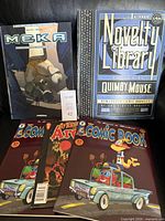 Front view of all five comics including Meka, Acme Novelty Library, two Comic Book issues, Afterlife with Archie