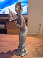Full side view of Lladró figurine showing parasol and overall form