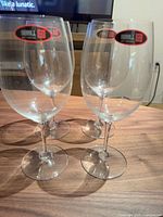 Set of four clear Riedel red wine glasses on table