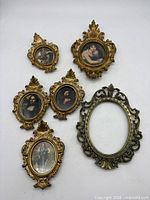 All seven small ornate oval frames displayed together