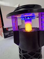 Insect trap powered on showing LED lights and housing detail