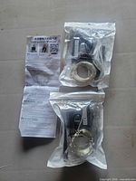 Two sealed bags each containing LED string and solar panel, instruction manual visible
