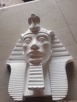 Front view of white plaster Pharaoh wall mask showing facial features and headdress