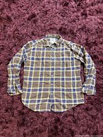 Front view of Armani Exchange plaid long sleeve shirt laid flat