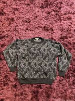 Full view of the sweater laid flat