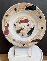 Front view of plate showing painted angel and star motif
