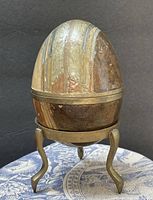 Full view of cloisonné enamel egg on brass tripod stand