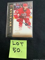 Front view of Sebastian Aho rookie card in sleeve showing serial number 131/599