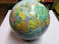 Full view of Replogle globe showing parts of Europe, Africa, Middle East, and Asia with clear raised land mass textures and various country borders.