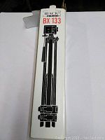 Tripod box front showing Blacks BX 133 model graphic and brief product illustration.