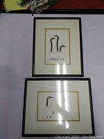 Two framed prints by Benjamin Chee Chee on a flat surface, showing stylized bird artwork.