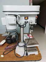 Front view of drill press showing motor housing, column and base