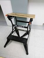 Black and Decker Workmate 200 workbench standing on a tiled floor, showing front side and structure.