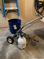 Broadcast spreader side view with sprayer in front
