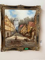 Frontal view of framed oil painting depicting German cityscape