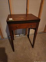 Cabinet closed showing top surface, knobs and legs