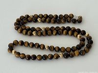 Full view of tiger eye bead necklace laid out