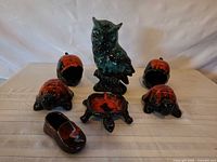 Group shot: owl figurine centred, six turtle dishes around, shoe dish front