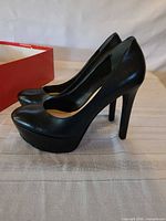 Left side view of both pumps showing heel height and platform