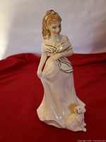 Front view of Royal Doulton Morning Walk figurine on red cloth