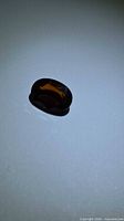 Top view of oval cognac fire orange tourmaline