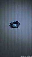 Top view of oval Swiss blue topaz showing facets and color