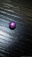 Top view of round star ruby showing six-ray star