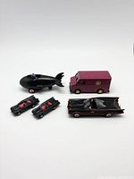 Group shot of all five vehicles: Bat-sub, Joker van, two small Batmobiles, large Batmobile