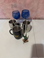 Group shot of all mugs, glasses and figurine