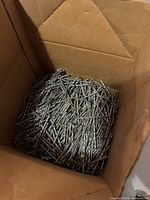 Interior of box showing large quantity of galvanized spiral nails