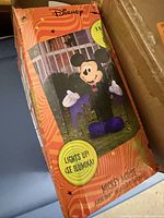 Front of retail box showing Mickey Mouse inflatable image and height indication