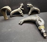 All four metal walking stick handles displayed