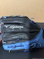 Back side of glove showing Mizuno branding and two-tone leather