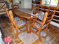 Front-angle view of table extended with chairs