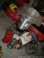 Overview showing fryer pot on burner stand, lanterns, briquettes, fuel containers
