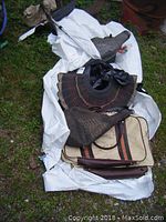 Photo of turkey decoys laying on white tarp, showing multiple decoys including turkey body and tail feather decoys alongside a carrying case and pole.