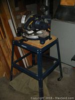 Mastercraft miter saw mounted on a metal stand with wooden platform.