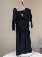 Front view of Reitmans black maxi wrap dress on hanger showing overall design and tag