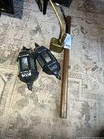 Copper instrument, brass water pipe, pair of lanterns overview