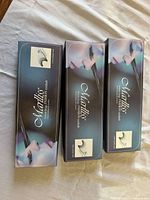 Three Marliss retail boxes closed; branding and style label visible