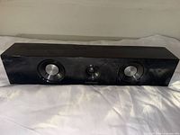 Front view showing three driver openings and overall cabinet condition