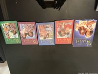 Front view of four colored DVD cases and outer blue slip box