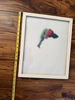 front view of framed print with tape measure showing height
