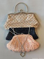 Three evening bags stacked to show fronts and size comparison