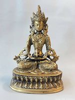 Front view of brass Amitayus Buddha statue on lotus base