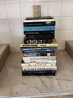 Full stack of 15 books showing spines and relative sizes