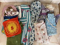 Overview of entire lot showing aprons, pot holders, oven mitts and towels