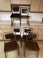 Front view of six Hamilton Cosco folding chairs showing overall design and quantity