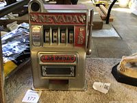 Front view showing graphics, reels, coin slot and payout tray