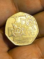 Close handheld view of reverse Victoria Cross design, highlighting detail